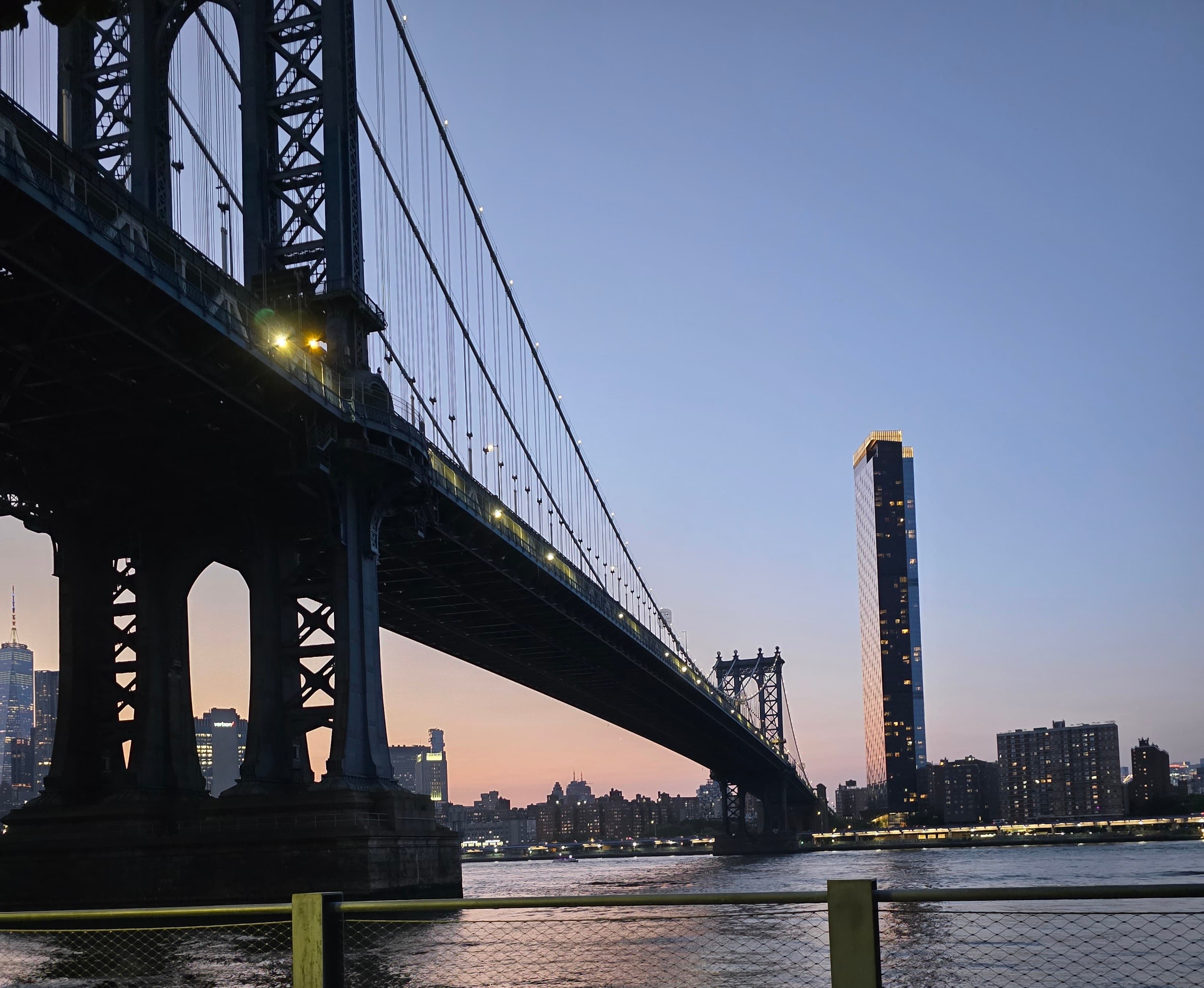 Manhattan Bridge at dusk with New York City skyline